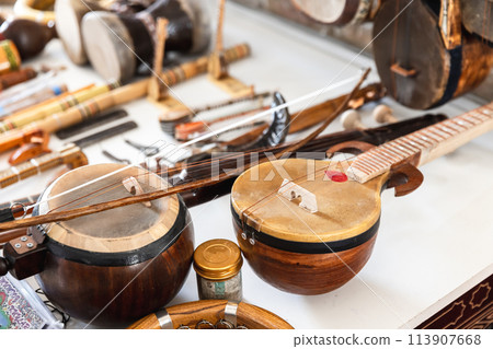 Central Asian stringed musical instruments are put up for sale at a bazaar Central Asian stringed musical instruments are put up for sale at a bazaar 113907668