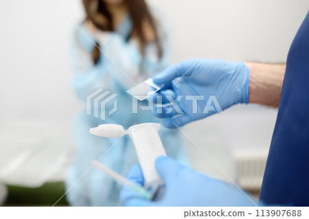 Mammalogist doctor is preparing to examine woman breasts and lymph nodes using ultrasound for diagnosis of breast cancer during appointment. Oncologist holding biopsy slide glasses and syringe. 113907688