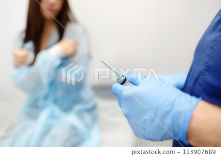Mammalogist doctor is preparing to examine woman breasts and lymph nodes using ultrasound for diagnosis of breast cancer during appointment. Oncologist holding biopsy slide glasses and syringe. Mammalogist doctor is preparing to examine woman breasts and lymph nodes using ultrasound for diagnosis of breast cancer during appointment. Oncologist holding biopsy slide glasses and syringe. 113907689