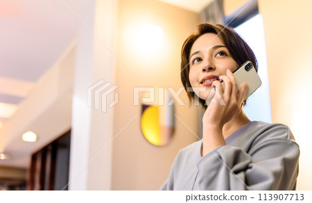 Elegant woman using a smartphone 113907713