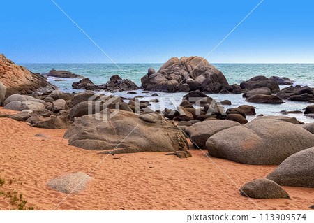 View of large rocks along the shore of the South China Sea. Sky Grottoes Park, Sanya, China View of large rocks along the shore of the South China Sea. Sky Grottoes Park, Sanya, China 113909574
