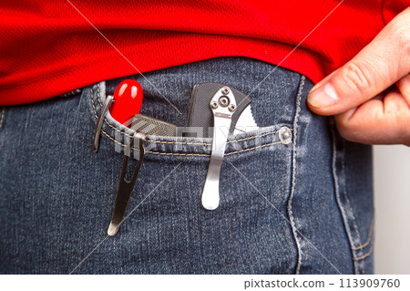 Pen, knife and flashlight with clips in your jeans pocket. EDC items 113909760