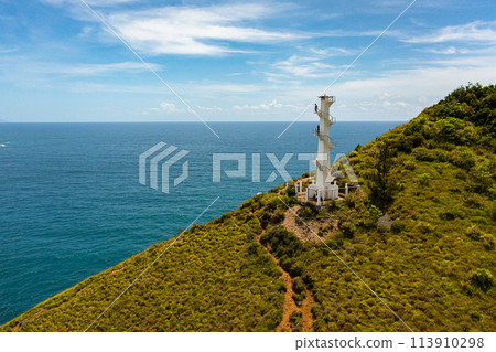 Aerial drone of Lighthouse on a hill against the blue sky. Santa Ana,Luzon, Philippines. 113910298