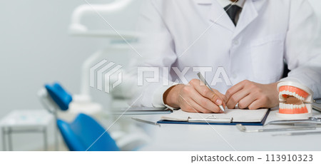 Dentist taking patient history . Dentist taking patient history . 113910323