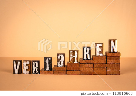 Procedure word in German. Wooden alphabet letters on a light background 113910663