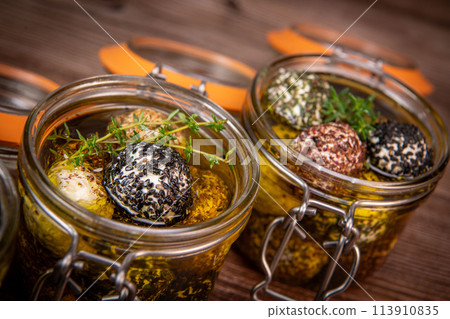 LABNEH CHEESE BOLLS WITH DRY MINT, BLACK AND WHITE SESAME, SUMAC AND ZAATAR IN A JAR WITH OLIVE OIL 113910835