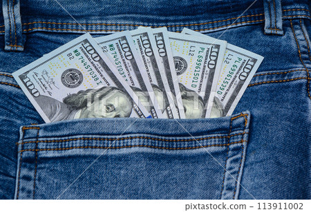 One hundred dollar banknote money in pocket jeans pants background texture. 100 dollar bill close up 1 One hundred dollar banknote money in pocket jeans pants background texture. 100 dollar bill close up 1 113911002