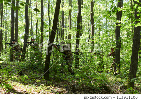 A specialized military antiterrorist unit conducts a covert operation in dense, hazardous woodland, demonstrating precision, discipline, and strategic readiness 113911106