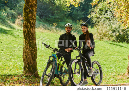 A sweet couple, equipped with bicycles and engrossed in coordinating their journey, checks their GPS mobile and watches while planning scenic routes in the park, seamlessly blending technology and A sweet couple, equipped with bicycles and engrossed in coordinating their journey, checks their GPS mobile and watches while planning scenic routes in the park, seamlessly blending technology and 113911146