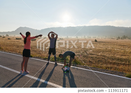 Diverse Athletes Prepare: Dynamic Group Warms Up for Morning Run. 113911171
