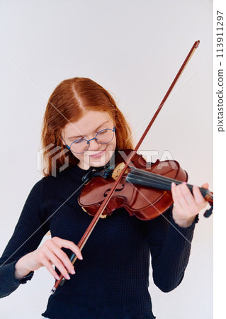 Stunning Redhead Musician Poses with Violin in Captivating Portrait 113911297