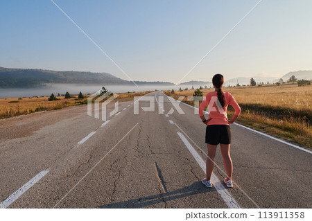 Determined Stretch: Athletic Woman Embraces Post-Run Flexibility in Nature. Determined Stretch: Athletic Woman Embraces Post-Run Flexibility in Nature. 113911358