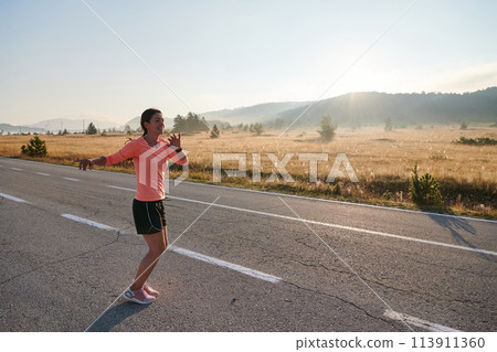 Determined Stretch: Athletic Woman Embraces Post-Run Flexibility in Nature. 113911360