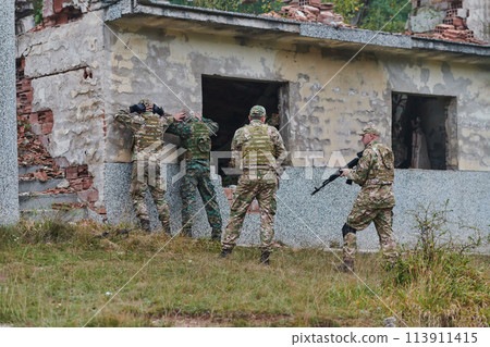 In a high stakes mission, a specialized military unit executes a tactical operation to secure a dangerous house where terrorists are believed to be hiding, showcasing precision and coordinated In a high stakes mission, a specialized military unit executes a tactical operation to secure a dangerous house where terrorists are believed to be hiding, showcasing precision and coordinated 113911415
