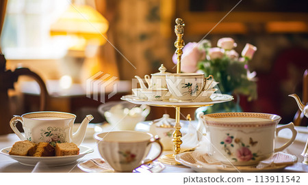 Elegant table setting for tea party with cakes and cupcakes in English manor. Vintage style. 113911542