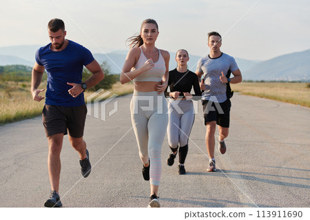 A group of friends maintains a healthy lifestyle by running outdoors on a sunny day, bonding over fitness and enjoying the energizing effects of exercise and nature 113911690