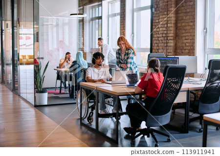 A diverse group of business professionals collaborates in a modern startup coworking center, utilizing a mix of paper-based and technological tools such as mobile phones and computers A diverse group of business professionals collaborates in a modern startup coworking center, utilizing a mix of paper-based and technological tools such as mobile phones and computers 113911941