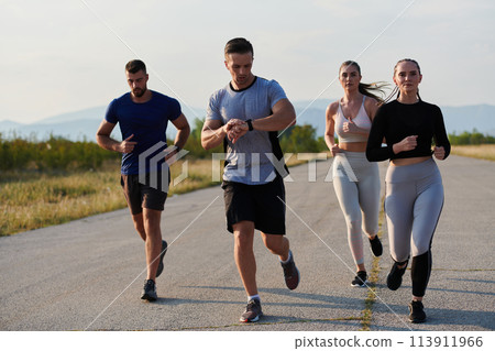 A group of friends maintains a healthy lifestyle by running outdoors on a sunny day, bonding over fitness and enjoying the energizing effects of exercise and nature 113911966