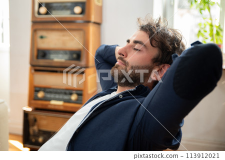 Young man enjoying relaxing day off at home Young man enjoying relaxing day off at home 113912021