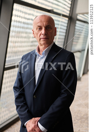 Portrait of an Experienced Businessman in Modern Conference Setting Portrait of an Experienced Businessman in Modern Conference Setting 113912125