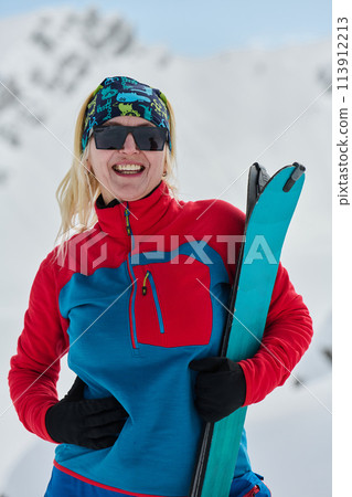 A Female Mountaineer Ascends the Alps with Backcountry Gear 113912213