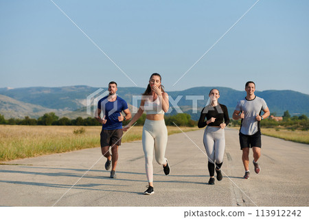 A group of friends maintains a healthy lifestyle by running outdoors on a sunny day, bonding over fitness and enjoying the energizing effects of exercise and nature 113912242