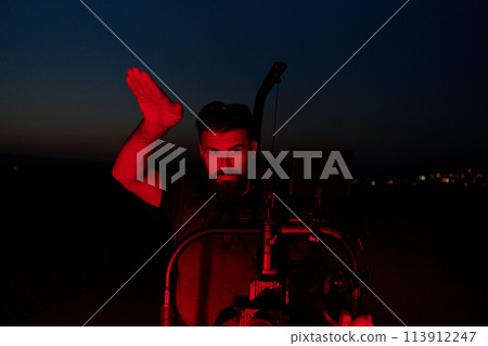Nighttime Capture: Professional Videographer Films Athletes Running in Red-Lit Darkness Nighttime Capture: Professional Videographer Films Athletes Running in Red-Lit Darkness 113912247