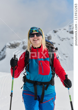A Female Mountaineer Ascends the Alps with Backcountry Gear 113912263