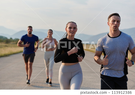A group of friends maintains a healthy lifestyle by running outdoors on a sunny day, bonding over fitness and enjoying the energizing effects of exercise and nature A group of friends maintains a healthy lifestyle by running outdoors on a sunny day, bonding over fitness and enjoying the energizing effects of exercise and nature 113912386