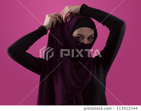 Modern Muslim woman wearing stylish hijab casual wear isolated on pink background. Diverse people model hijab fashion concept. Modern Muslim woman wearing stylish hijab casual wear isolated on pink background. Diverse people model hijab fashion concept. 113912544