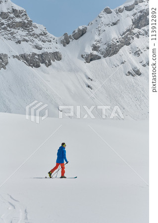 A Skier Scales a Treacherous Alpine Peak A Skier Scales a Treacherous Alpine Peak 113912892