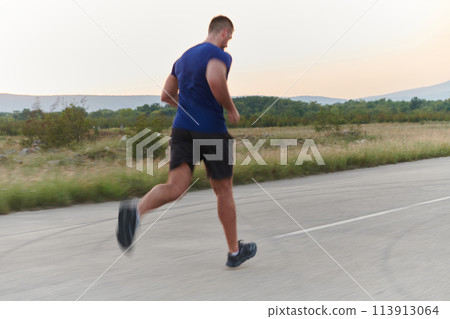 A dedicated marathon runner pushes himself to the limit in training. 113913064