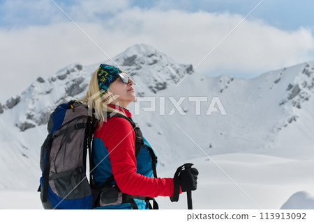 A Female Mountaineer Ascends the Alps with Backcountry Gear 113913092