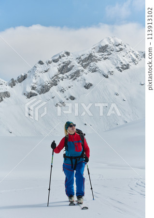 A Female Mountaineer Ascends the Alps with Backcountry Gear 113913102