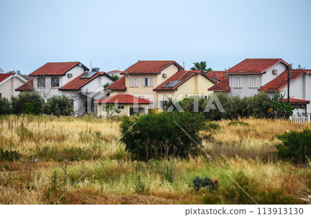 complex of houses with red roofs against the backdrop of the sea in Northern Cyprus 10 113913130