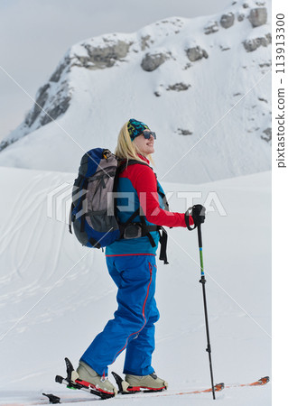 A Female Mountaineer Ascends the Alps with Backcountry Gear 113913300