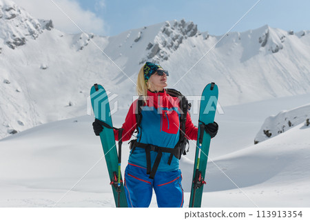 A Female Mountaineer Ascends the Alps with Backcountry Gear 113913354