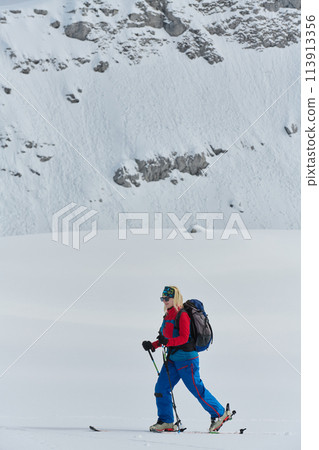 A professional woman skier rejoices after successfully climbing the snowy peaks of the Alps A professional woman skier rejoices after successfully climbing the snowy peaks of the Alps 113913356