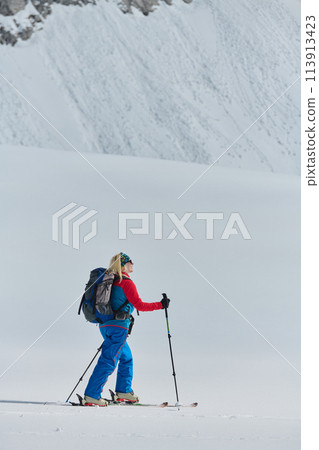 A Female Mountaineer Ascends the Alps with Backcountry Gear 113913423