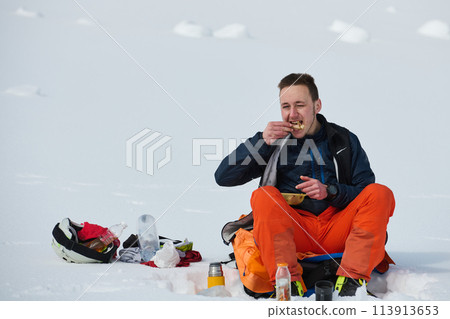 A Skier Takes a Well-Deserved Break to Enjoy the View 113913653