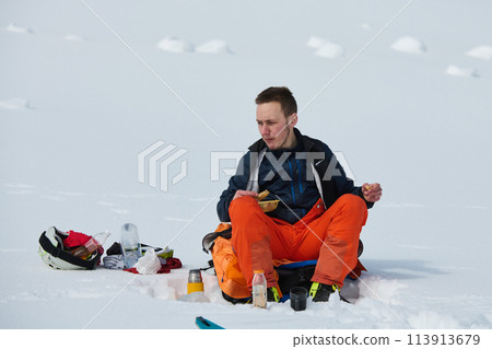 A Skier Takes a Well-Deserved Break to Enjoy the View 113913679