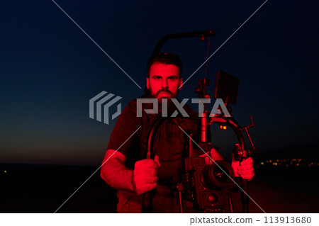 Nighttime Capture: Professional Videographer Films Athletes Running in Red-Lit Darkness 113913680