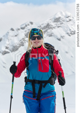 A Female Mountaineer Ascends the Alps with Backcountry Gear 113913788