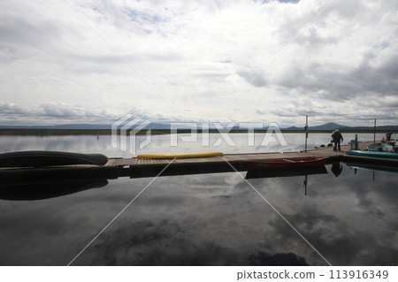 Boats in a marina on a lake 113916349