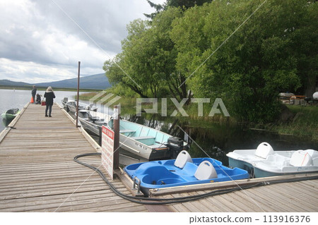 Boats in a marina on a lake 113916376