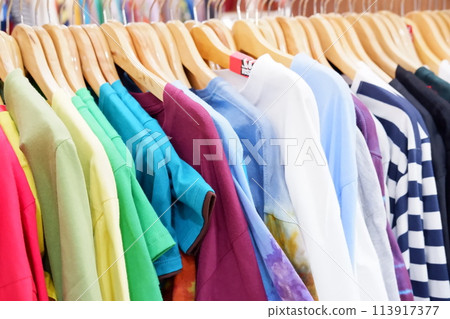colorful clothes on hangers in a shop 113917377