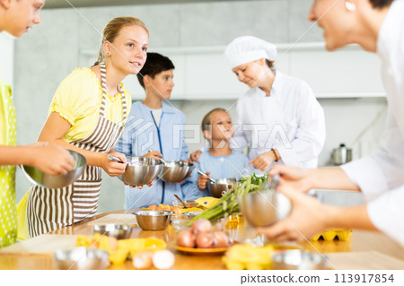 Chef apprentices learn how to properly beat eggs with a whisk in cooking class Chef apprentices learn how to properly beat eggs with a whisk in cooking class 113917854