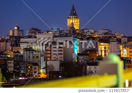 Llighted Galata Tower topping over Beyoglu residential buildings, Istanbul 113917857