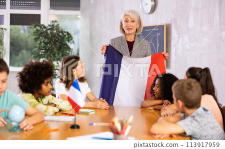 students listen to woman teacher who talks about France students listen to woman teacher who talks about France 113917959