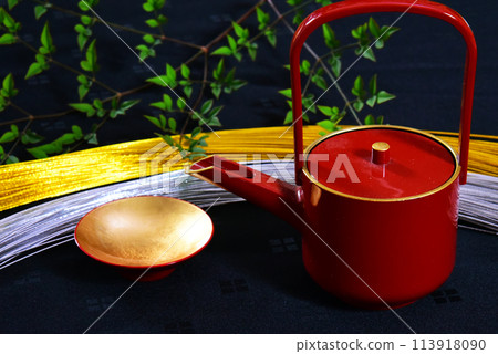 A traditional Japanese golden celebratory cup and gold and silver celebratory cord used at weddings and Shinto ceremonies. A traditional Japanese golden celebratory cup and gold and silver celebratory cord used at weddings and Shinto ceremonies. 113918090